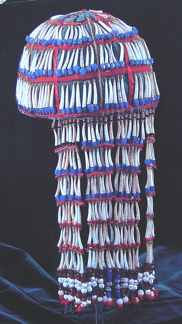 This is a wedding veil covered with dentalia shells and blue glass beads