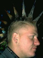 Photo of a young man with spiked hair and a studded leather collar