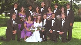 photo of a North American wedding party with the bride and groom in the middle and the other members of the wedding party assembled at their sides and behind them