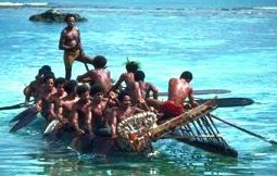 photo of 12 Trobriand Island men on a small trading canoe