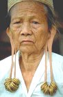 photo of a Dyak woman from Borneo showing very long ears stretched by many metal rings