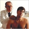 Photo of a Western trained medical doctor giving a man a physical exam