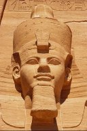 Photo of a monumental statue from ancient Egypt depicting the head of a powerful pharaoh