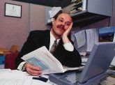 photo of a very over-worked man in a business office