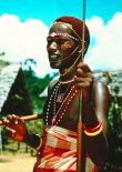 photo of a Masai man in traditional dress and holding a spear