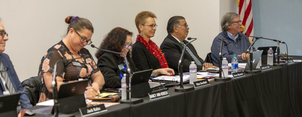 Members of the Palomar College Governing Board  listen and take notes as an attendee presents their case on  Tuesday, March 10, 2020. (l-r) Jack Kahn, Nancy Ann Hensch, Nina Deerfield, Norma Miyamoto, John Halcón, Mark Evilsizer. ( Adel M. Bautista/The Telescope)