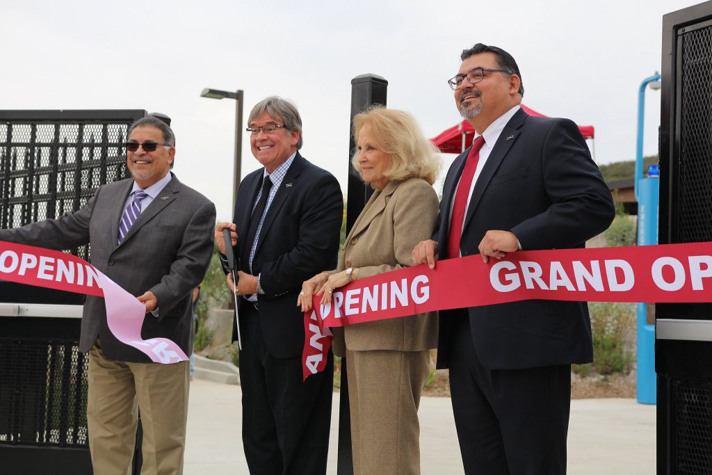 Mark Evilsizer cuts the ribbon at the grand opening of the new baseball field with John Halcón (l) and Nancy Chadwick and Interim President Adrian Gonzales to his left.  (Michaela Sanderson/The Telescope)